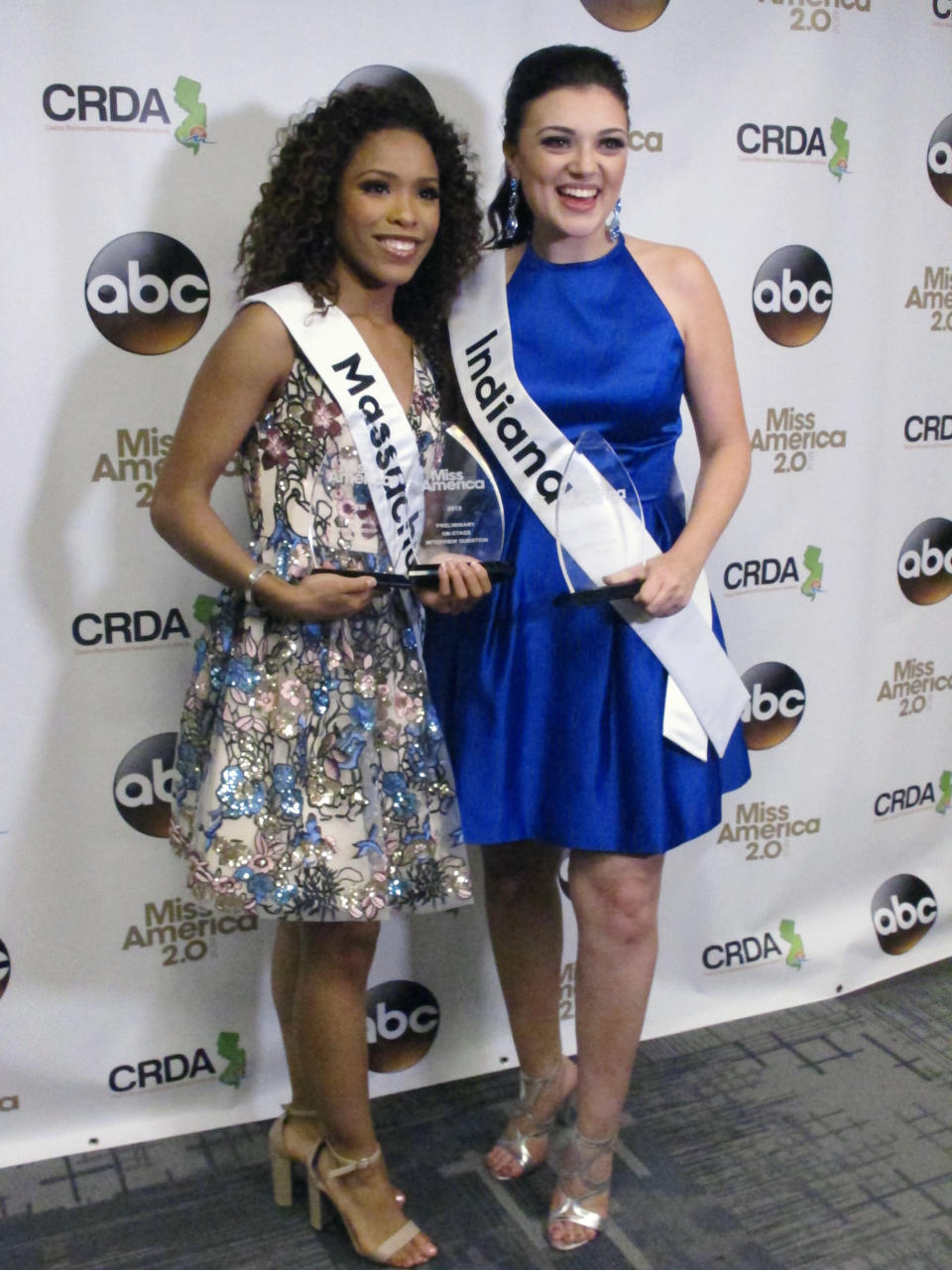 Miss Massachusetts Gabriela Taveras, left, and Miss Indiana Lydia Tremaine pose for photos after winning preliminary competition awards in the Miss America pageant Friday Sept. 7, 2018 in Atlantic City, N.J. Taveras won the onstage interview and Tremaine won the talent portion. (AP Photo/Wayne Parry)