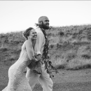 <p>In an embroidered gown with her new husband Travis Browne. (The two wed during the same day as the <a rel="nofollow noopener" href="http://www.tmz.com/2017/08/29/ronda-rousey-travis-browne-first-wedding-pic/" target="_blank" data-ylk="slk:the McGregor vs. Floyd Mayweather fight;elm:context_link;itc:0;sec:content-canvas" class="link ">the McGregor vs. Floyd Mayweather fight</a>.) </p>