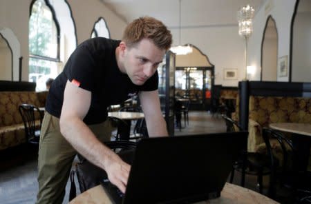 Austrian lawyer and privacy activist Max Schrems prepares his laptop during a Reuters interview in a cafe in Vienna, Austria, May 22, 2018. Picture taken May 22, 2018. REUTERS/Heinz-Peter Bader