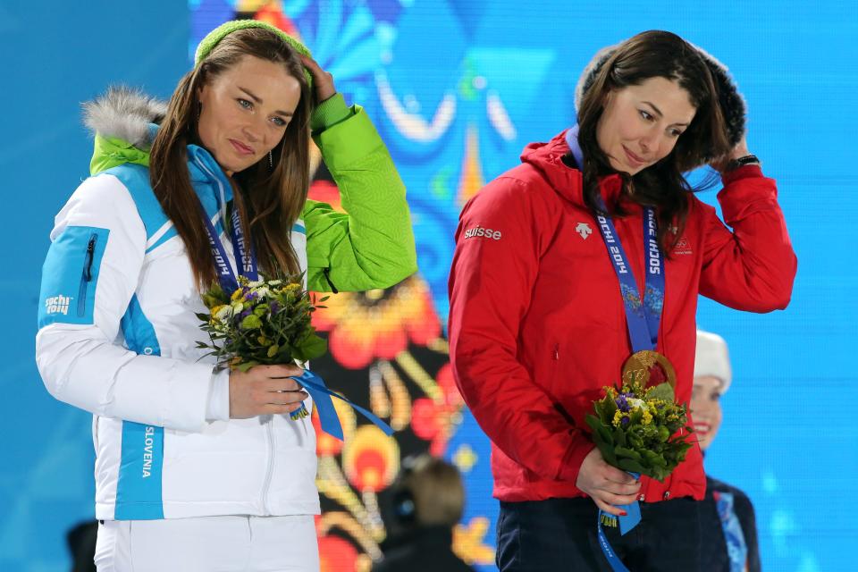 Gold medalists Switzerland’s Dominique Gisin (R) and Slovenia’s Tina Maze pose on the podium during the Women’s Alpine Skiing Downhill Medal Ceremony at the Sochi medals plaza on February 12, 2014.(Getty Images)