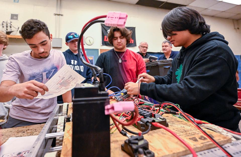 Redwood students Jace Ortiz, left, Alexander Hanson, and Dominic Mascia, work after school with Dylan Asunto, right, and other University Preparatory High School students on a robotics project Wednesday, November 15, 2023. Redwood High School’s Robotics team will compete in the Central Valley Regional at the Fresno Fairgrounds thanks to a $6,000 NASA grant.