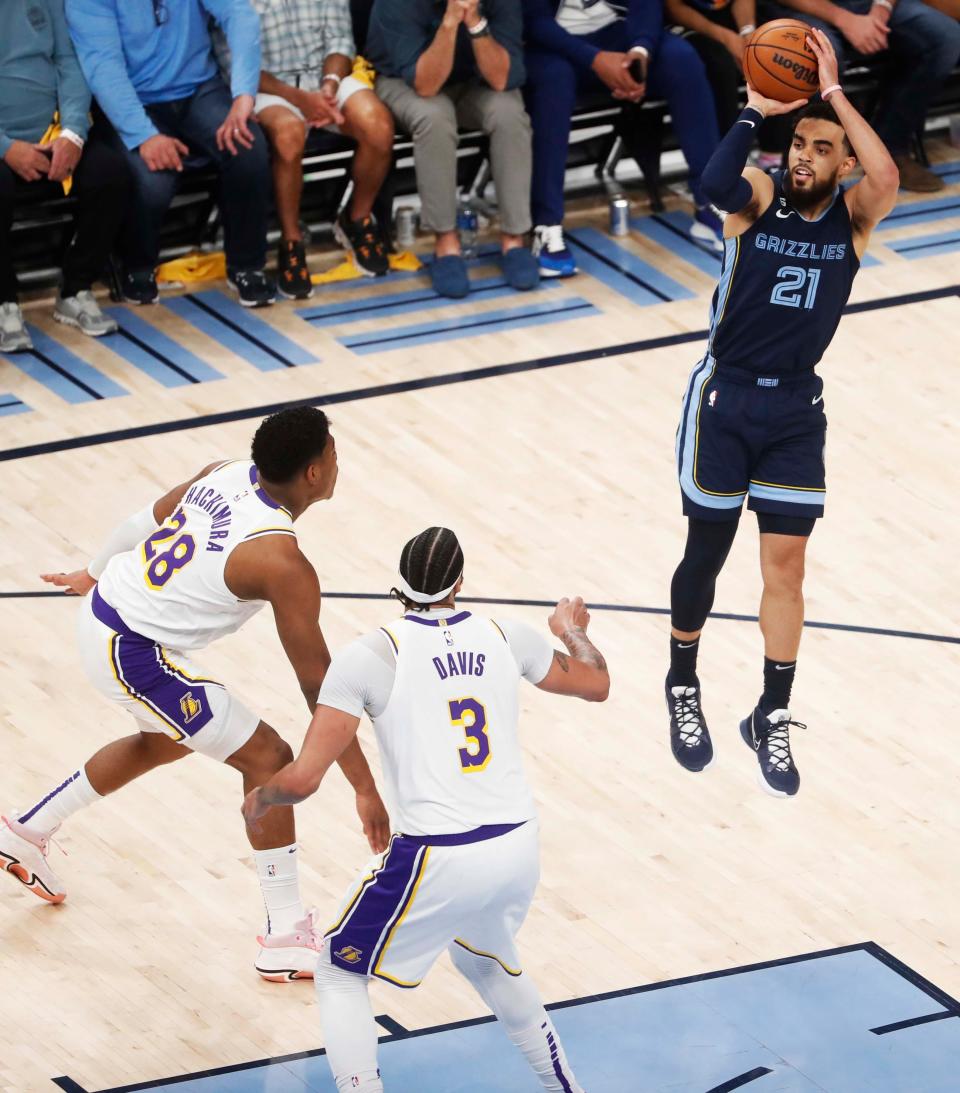 Grizzlies’ Tyus Jones (21) shoots the balll over Lakers’ Anthony Davis (3) and Rui Hachimura (28) in the third quarter of Game 1 between the Memphis Grizzlies and LA Lakers in their first round NBA playoffs series on April 16, 2023 at FedExForum. 