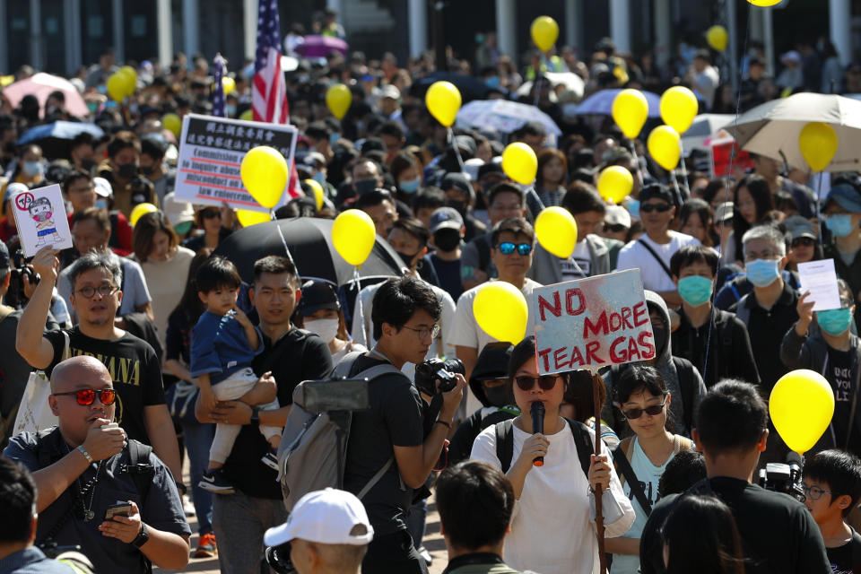 People hold balloons march as they take part in a "No Tear Gas" rally in Hong Kong, Sunday, Dec. 1, 2019. About 200 people are marching against police use of tear gas as Hong Kong readies for a day of protests. The group carried yellow balloons as they headed Sunday morning from Edinburgh Square to the nearby government headquarters. (AP Photo/Vincent Thian)