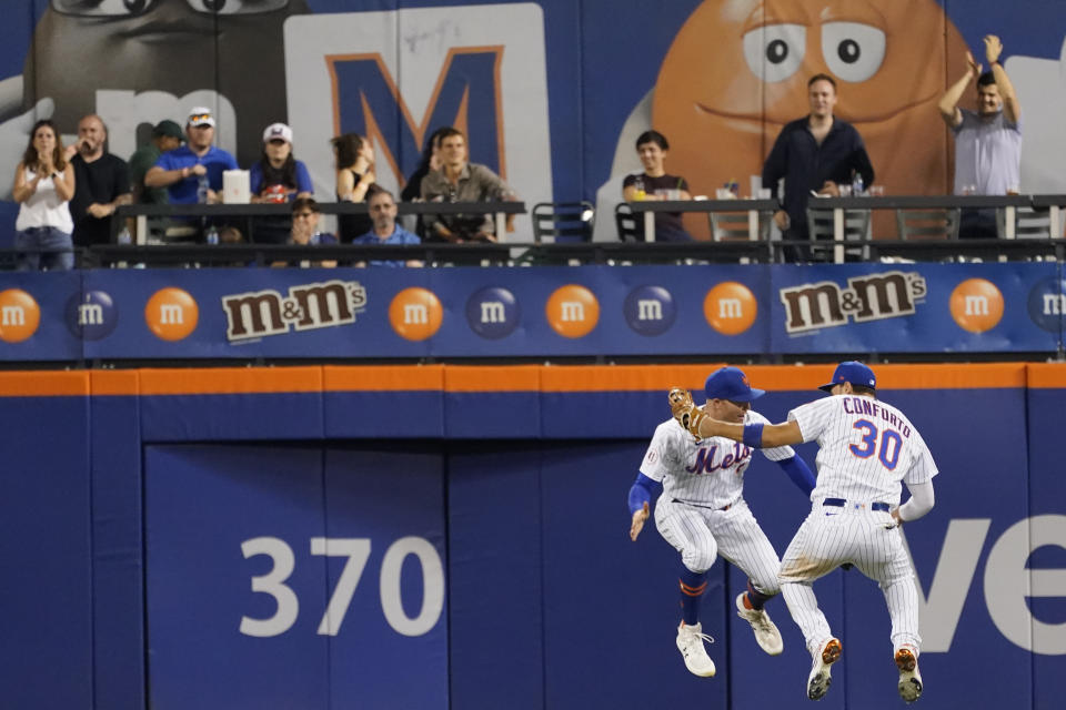 New York Mets' Michael Conforto (30) and Brandon Nimmo celebrate after Atlanta Braves during their baseball game, Wednesday, July 28, 2021, in New York. The Mets won 2-1. (AP Photo/Mary Altaffer)