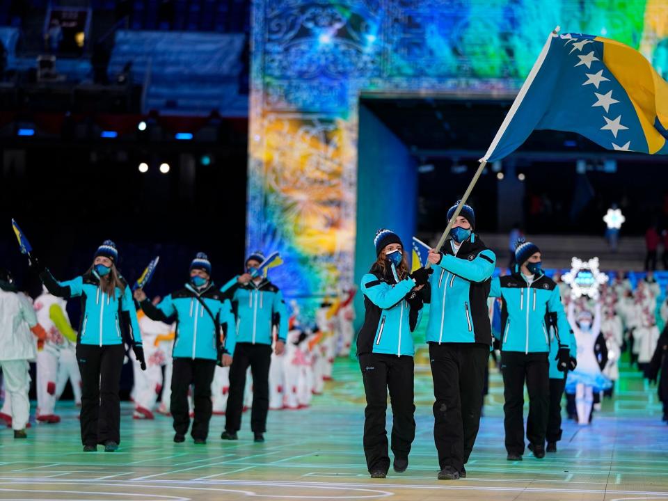 Athletes from Bosnia and Herzegovina make their entrance at the 2022 Winter Olympics.