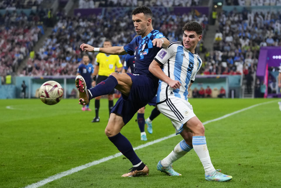 Croatia's Ivan Perisic, left, and Argentina's Julian Alvarez battle for the ball during the World Cup semifinal soccer match between Argentina and Croatia at the Lusail Stadium in Lusail, Qatar, Tuesday, Dec. 13, 2022. (AP Photo/Petr David Josek)