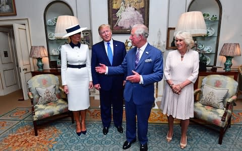 US President Donald Trump and his wife Melania (left) at Clarence House in London to take tea with the Prince of Wales and Duchess of Cornwall on the first day of his state visit to the UK - Credit: Victoria Jones/PA