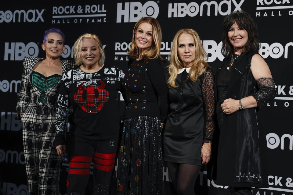 From left to right, Jane Wiedlin, Gina Schock, Belinda Carlisle, Charlotte Caffey and Kathy Valentine of The Go-Go’s pose in the press room during the Rock & Roll Hall of Fame induction ceremony, Saturday, Oct. 30, 2021, in Cleveland. (AP Photo/Ron Schwane) - Credit: AP