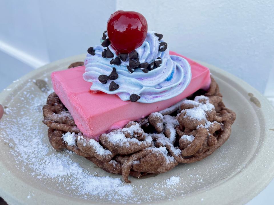 cherry blossom funnel cake with whipped cream and chocolate chips america pavilion epcot
