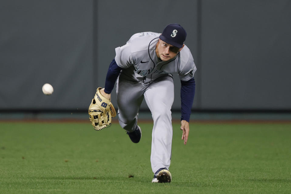 Seattle Mariners right fielder Mitch Haniger chases an RBI single hit by Kansas City Royals' Nate Eaton during the third inning of a baseball game in Kansas City, Mo., Friday, Sept. 23, 2022. (AP Photo/Colin E. Braley)