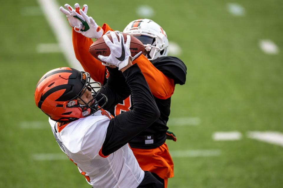 Wide receiver Andrei Iosivas of Princeton (9) grabs a pass with tight defense by defensive back Tyrique Stevenson of Miami (8) during the second day of Senior Bowl week at Hancock Whitney Stadium in Mobile.