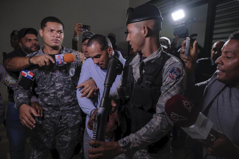 FILE - Tampa Bay Rays shortstop Wander Franco, center, is escorted by police from a courtroom in Puerto Plata, Dominican Republic, Friday, Jan. 5, 2024. Rays' Wander Franco was placed on administrative leave through June 1 under an agreement between Major League Baseball and the players' association while the investigation continues in an alleged relationship with a minor. The Rays open the season Thursday, March 28, 2024, against Toronto, forcing MLB and the union to make a decision on Franco's roster status. (AP Photo/Ricardo Hernandez, File)