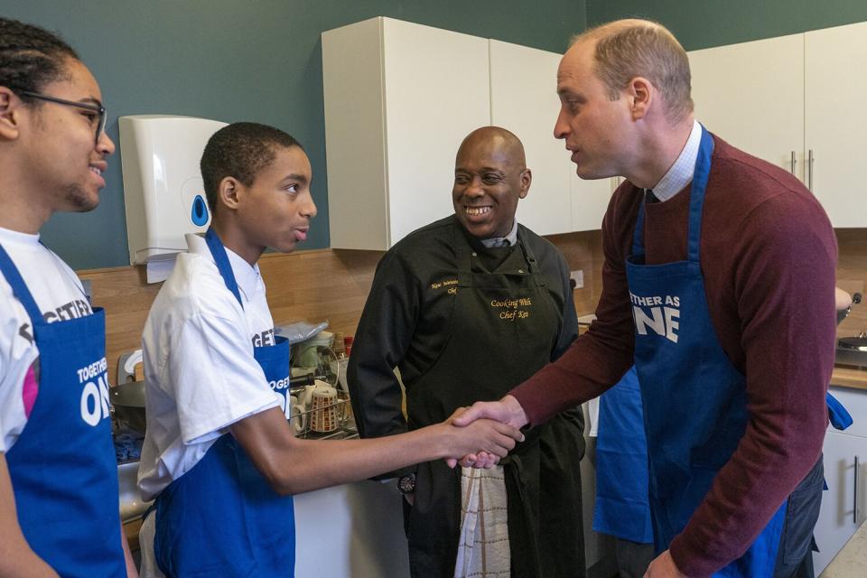 Prince William shakes hands with Ramae Bogle 13, during his visit to Together as One, until recently known as Aik Saath, in Slough