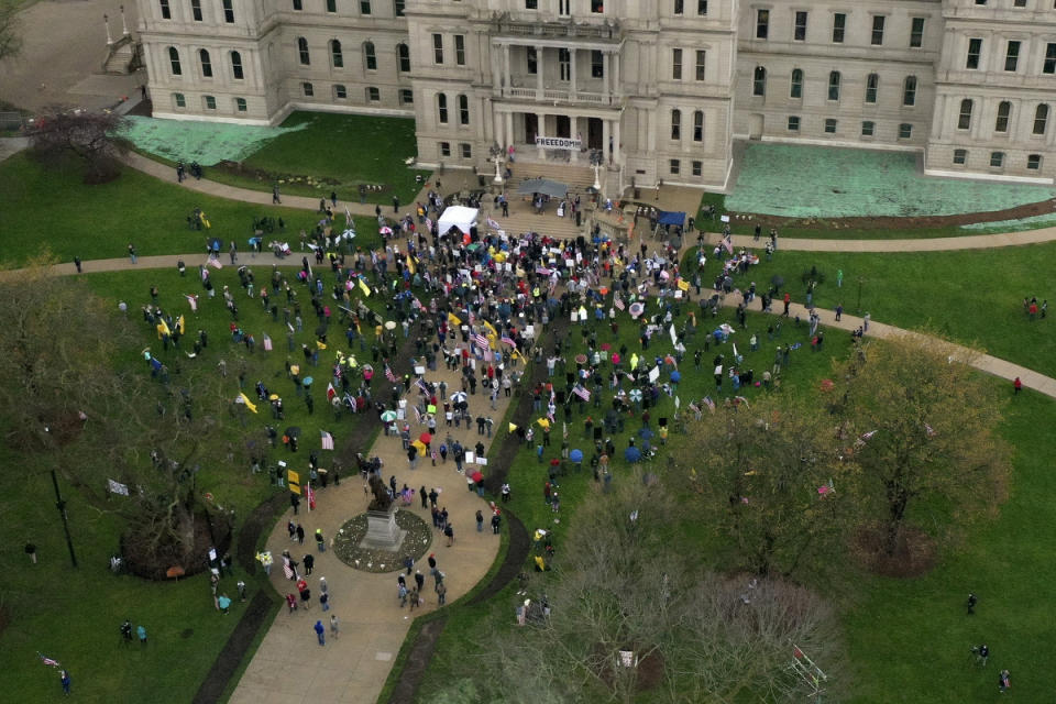 Protesters congregate at the Capitol building to denounce the governor's stay-at-home order in Lansing, Mich. on Thursday April 30, 2020. The Republican-led Michigan House refused to extend the state's coronavirus emergency declaration and voted to authorize a lawsuit challenging Democratic Gov. Gretchen Whitmer's authority and actions to combat the pandemic. (Neil Blake/The Grand Rapids Press via AP)