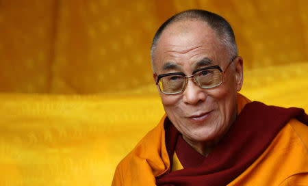 FILE PHOTO: Tibetan spiritual leader the Dalai Lama watches a dance performance on the last day of his teachings in Tawang in the northeastern Indian state of Arunchal Pradesh November 11, 2009. REUTERS/Adnan Abidi/File Photo