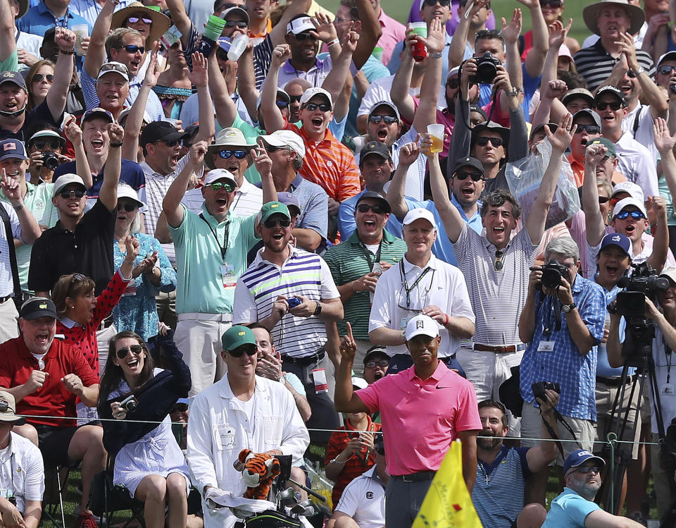 The massive gallery following Tiger Woods reacts as he chips in for an eagle on the second hole during practice for the Masters golf tournament at Augusta National Golf Club, Monday, April 2, 2018, in Augusta, Ga. (AP)