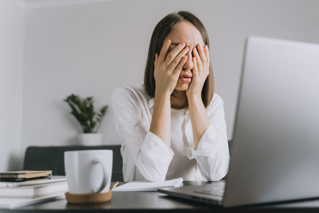 Woman at her computer suffering from stress. (Getty Images)