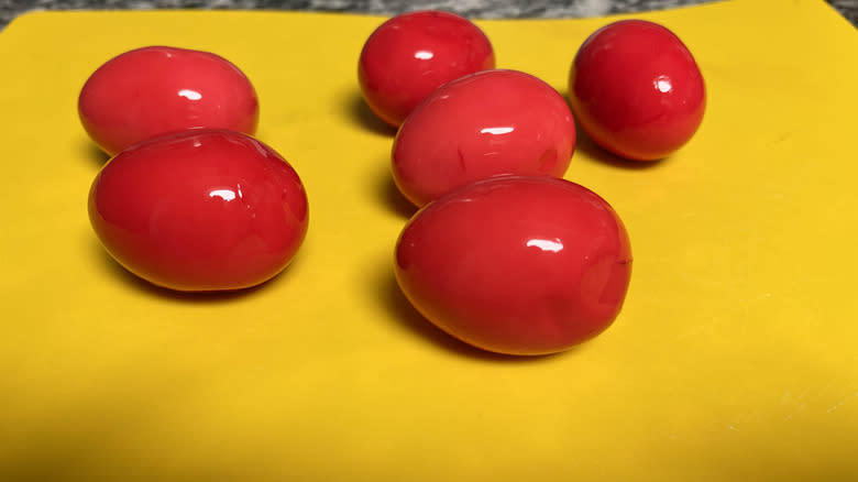 pink eggs on yellow surface