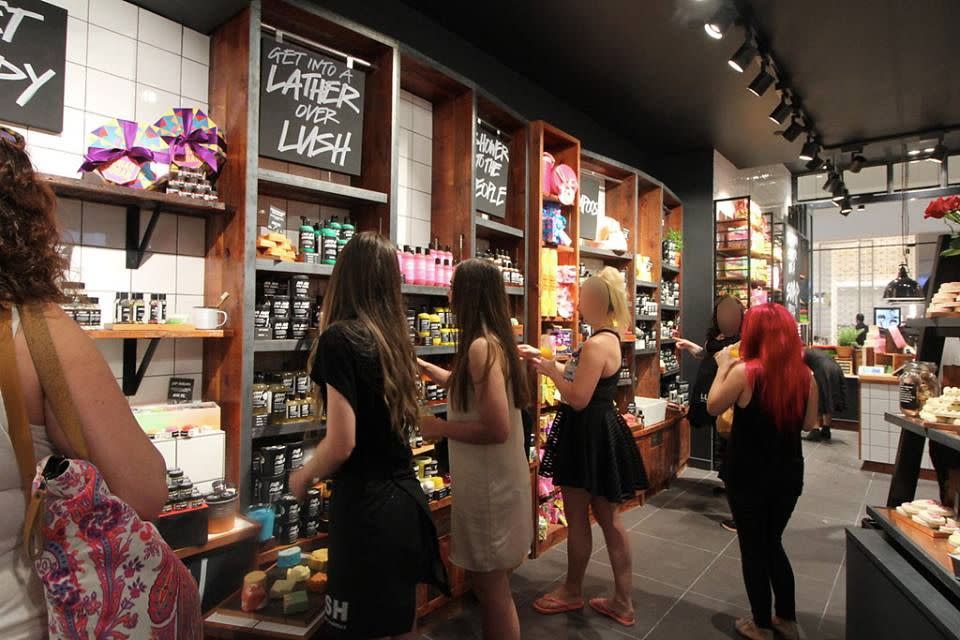 Shoppers in an Australian Lush store are pictured standing in front of a stand of 'Snow Fairy' body washes. Source: Facebook/Lush