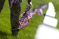 <p>Members of the Old Guard with the Washington Memorial in the back, place flags in front of every headstone at Arlington National Cemetery in Arlington, Va., Thursday, May 26, 2016. Soldiers were to place nearly a quarter of a million American flags at the cemetery as part of a Memorial Day tradition. (AP Photo/Jose Luis Magana) </p>