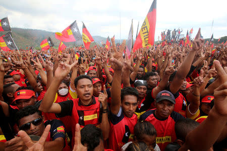 FILE PHOTO: Supporters of the Revolutionary Front for an Independent East Timor (FRETILIN) political party shout during a rally on the last day of campaigning ahead of this weekend's parliamentary elections in Dili, East Timor July 19, 2017. REUTERS/Lirio Da Fonseca/File Photo