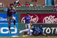 Jun 16, 2018; Arlington, TX, USA; Colorado Rockies shortstop Trevor Story (27) turns a double play as Texas Rangers first baseman Ronald Guzman (67) is out at second base during the third inning at Globe Life Park in Arlington. Mandatory Credit: Jerome Miron-USA TODAY Sports