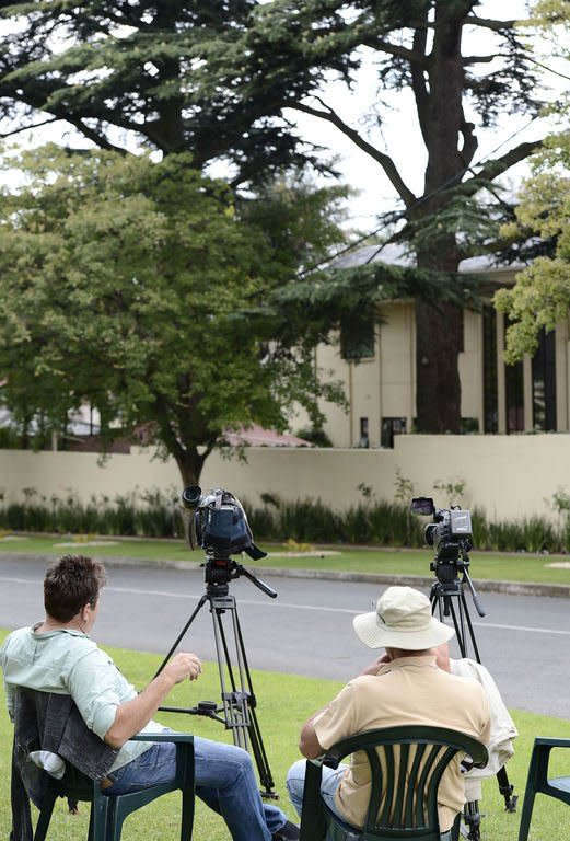 Journalists wait outside the house of former South African president Nelson Mandela on December 21, 2012 in Houghton, Johannesburg. Mandela will spend Christmas Day in hospital, the South African government said Monday, dashing hopes for a festive end to his longest stay in care since being released from prison in 1990