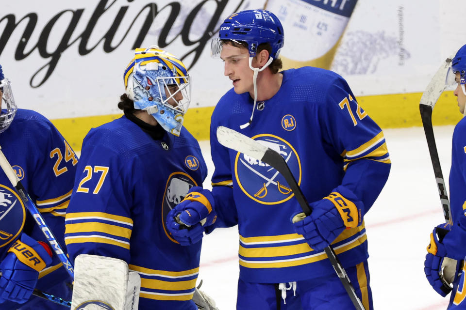 Buffalo Sabres goaltender Devon Levi (27) and right wing Tage Thompson (72) celebrate after a victory in an NHL hockey game against the Minnesota Wild, Friday, Nov. 10, 2023, in Buffalo N.Y. (AP Photo/Jeffrey T. Barnes)