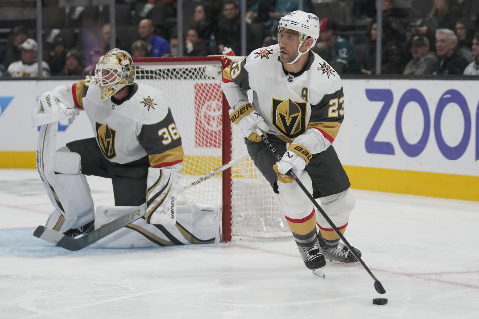 Vegas Golden Knights defenseman Alec Martinez (23) skates with the puck against the San Jose Sharks during the first period of an NHL hockey game in San Jose, Calif., Monday, Feb. 19, 2024. (AP Photo/Jeff Chiu)
