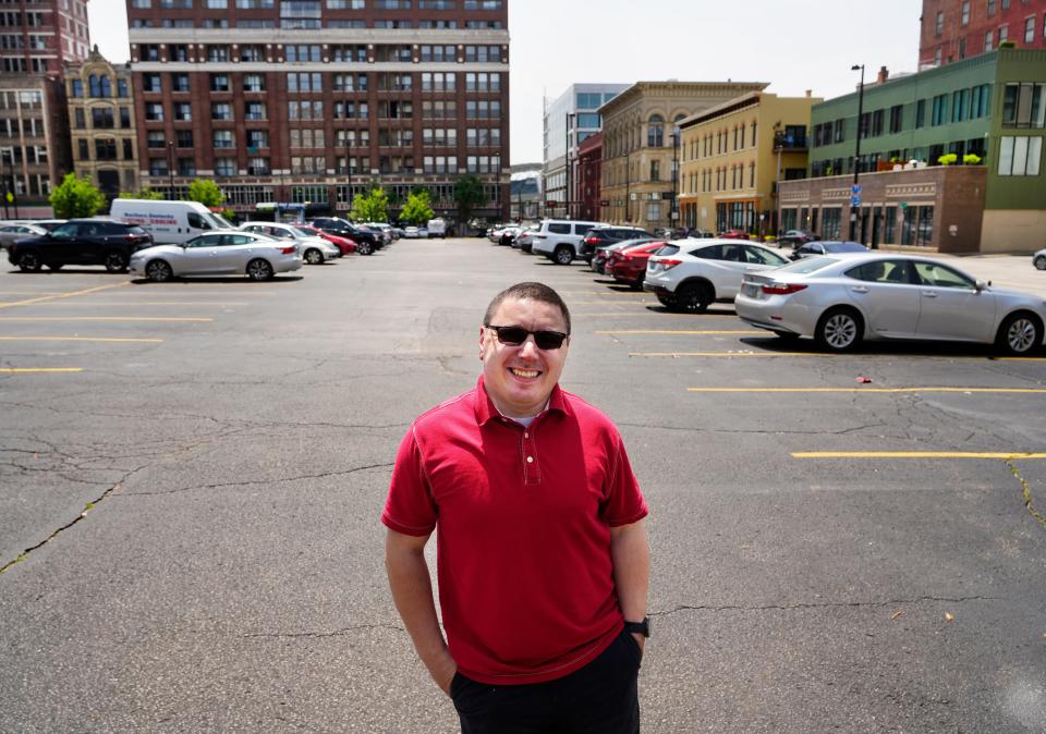 Alex Yurchak is a Downtown resident of West Fifth Street and works at Fountain Square. Here, he's photographed at a parking lot on Plum Street where the city's new convention center hotel will be built.