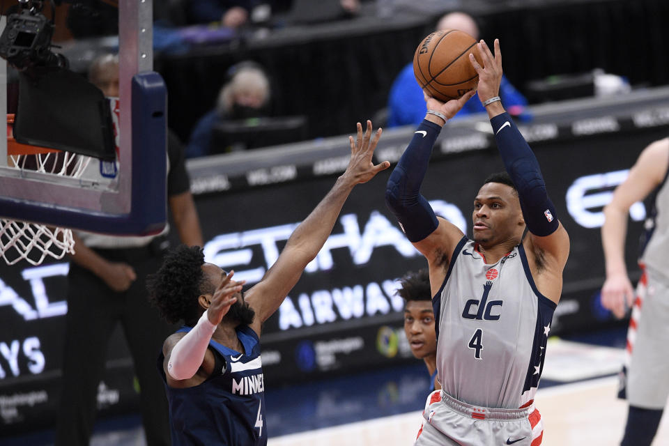 Washington Wizards guard Russell Westbrook, right, shoots against Minnesota Timberwolves guard Jaylen Nowell, left, during the first half of an NBA basketball game, Saturday, Feb. 27, 2021, in Washington. (AP Photo/Nick Wass)
