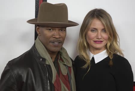 Actors Jamie Foxx (L) and Cameron Diaz pose for photographers during a photocall for their film Annie, in central London December 16, 2014. REUTERS/Neil Hall