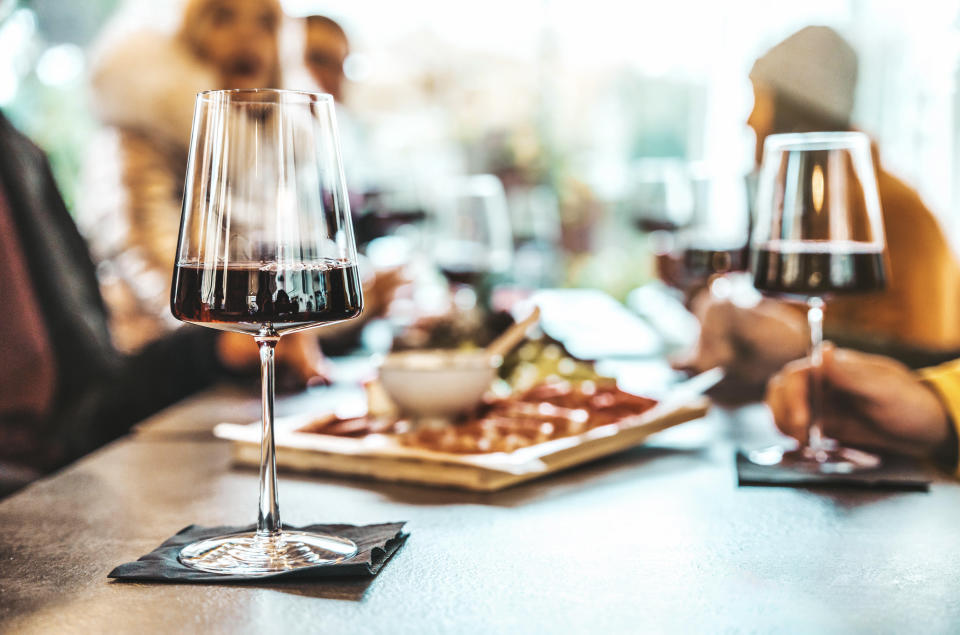 people having wine with a shared snack plate