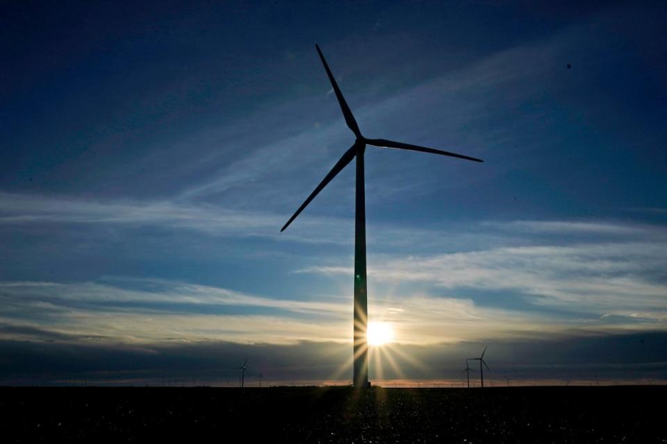 In this Jan. 13, 2021, file photo a wind turbine is silhouetted against the rising sun Wednesday, Jan. 13, 2021, near Spearville, Kan. A short-term forecast shows Alberta and Saskatchewan are expected to see a boom in renewable projects.