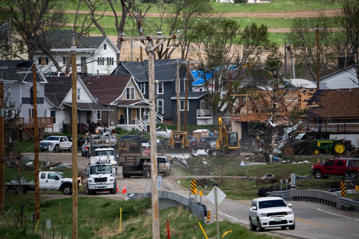 Residents and cleanup crews work to clear debris and restore power after a tornado ravaged the small town of Minden, Iowa, from the April 26, 2024, EF3 tornado.