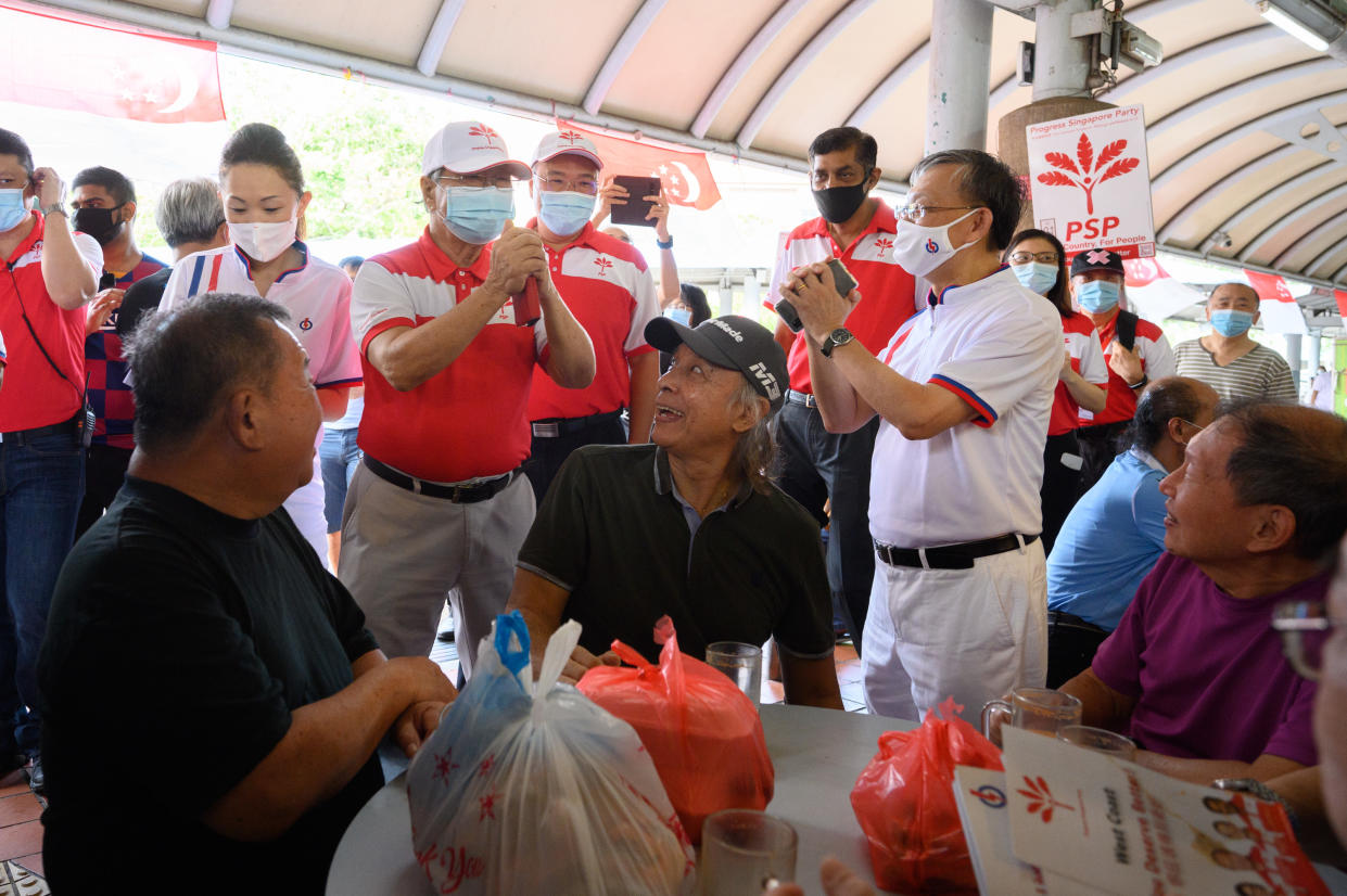 PSP chief Tan Cheng Bock greets a PAP member and residents during a party walkabout on Saturday (4 July). (PHOTO: Joseph Nair for Yahoo News Singapore)