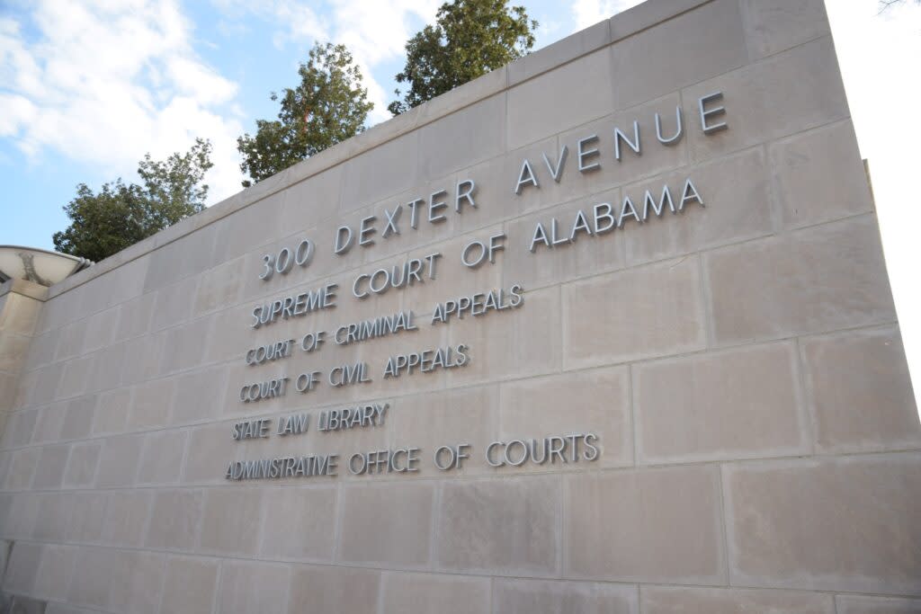 Silver letter on the brick says "300 Dexter Avenue. Supreme Court of Alabama. Court of Criminal Appeals. Court of Civil Appeals. State Law Library. Administrative Office of Courts."