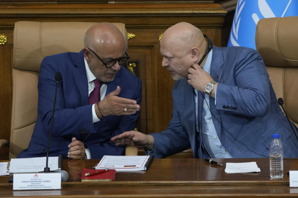 Karim Khan, chief prosecutor of International Criminal Court, right, speaks with National Assembly President Jorge Rodriguez at the National Assembly in Caracas, Venezuela, Monday, April 22, 2024. (AP Photo/Ariana Cubillos)