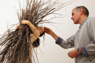 Artist Ron Mueck puts the finishing touches to his piece 'Woman with Sticks' at the Hauser & Wirth gallery on April 16, 2012 in London, England. The piece makes up part of a series of four 'lifelike' sculptures, and form Mueck's first major solo exhibition in over a decade on display from April 19 to May 26. (Photo by Dan Kitwood/Getty Images)