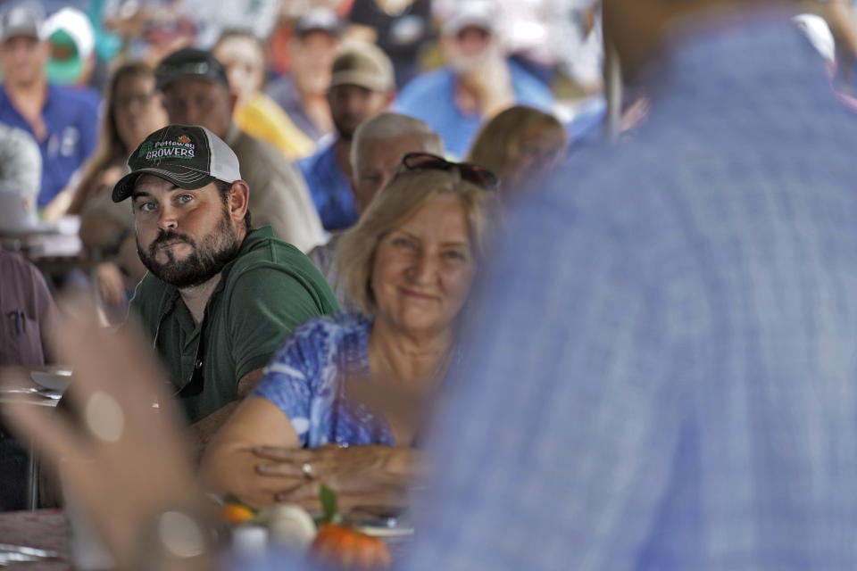 Fifth generation farmer Roy Petteway, left, listens as U.S. Sen. Marco Rubio, R-Fla., speaks to farmers about getting help from the damage caused by Hurricane Ian Wednesday, Oct. 12, 2022, in Zolfo Springs, Fla. (AP Photo/Chris O'Meara)