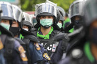 Riot police wearing face masks with their riot gear stand by during a pro-democracy demonstration in Bangkok, Thailand, Thursday, June 24, 2021. Pro-democracy demonstrators have taken to the streets of Thailand's capital again, marking the 89th anniversary of the overthrow of the country's absolute monarchy by renewing their demands that the government step down, the constitution be amended and the monarchy become more accountable. (AP Photo/Wason Wanichakorn)