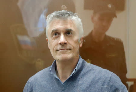 Founder of the Baring Vostok private equity group Michael Calvey, who was detained on suspicion of fraud, sits inside a defendants' cage as he attends a court hearing in Moscow, Russia February 15, 2019. REUTERS/Tatyana Makeyeva