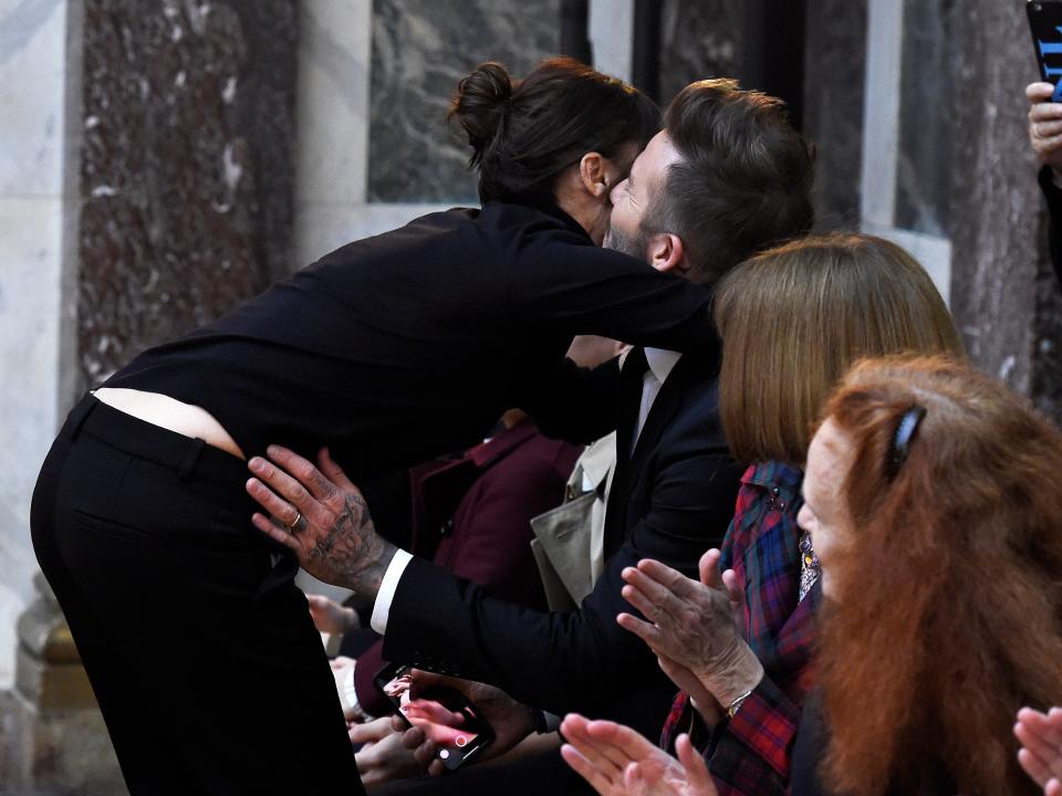 Victoria Beckham and David Beckham embrace after her 2018 New York Fashion Week show.