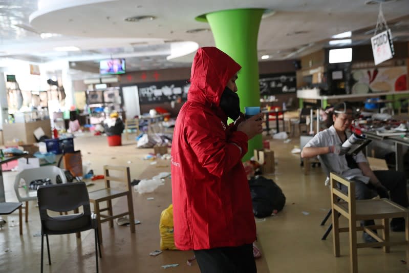 A PolyU student drinks coffee and watches the news in a canteen in Hong Kong Polytechnic University (PolyU)