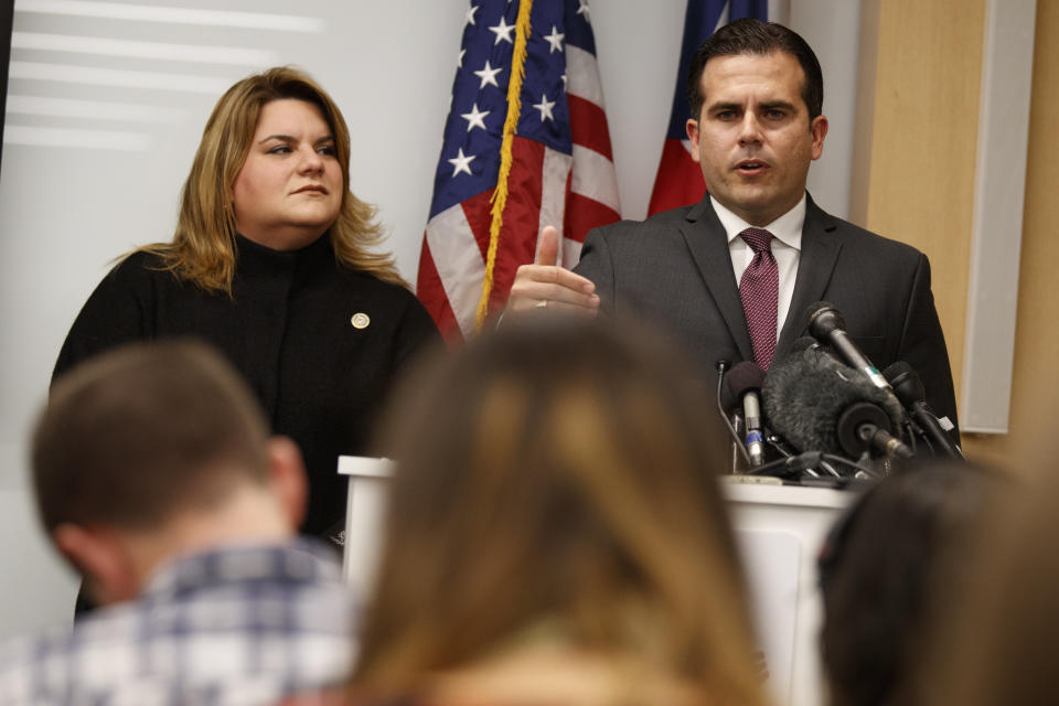 Resident Commissioner Jenniffer Gonzalez-Colon, who represents Puerto Rico as a nonvoting member of Congress, listens as Puerto Rico Gov. Ricardo Rossello speaks during a news conference. (AP Photo/Evan Vucci)