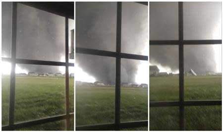 Combination of three video stills shows an active tornado as it touches down in Washington, Illinois