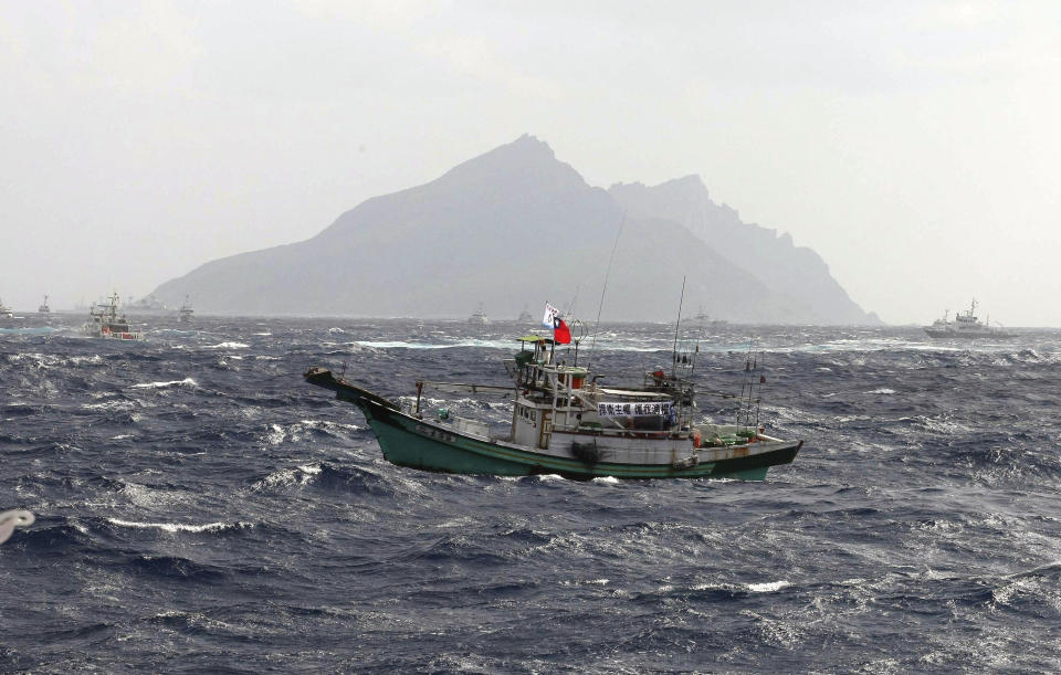In this photo released by Taiwan's Central News Agency, a Taiwanese fishing boat comes close to the disputed islands called Senkaku in Japan and Diaoyu in China, in the East China Sea, Tuesday, Sept. 25, 2012. On Tuesday morning, about 50 Taiwanese fishing boats accompanied by 10 Taiwanese surveillance ships came within almost 20 kilometers (about 12 miles) of the disputed islands- within what Japan considers to be its territorial waters. (AP Photo/Central News Agency) TAIWAN OUT