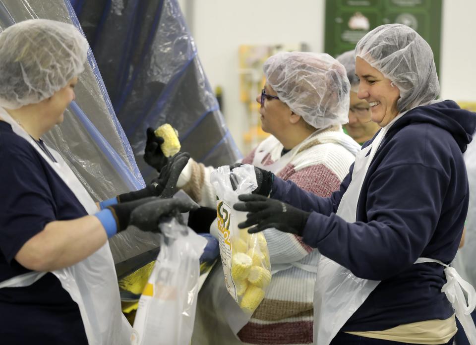 Green Bay Press-Gazette sports editor Julie Larson, left, and Appleton Post-Crescent editorial assistant Mara Wegner, center, volunteer at Feeding America Eastern Wisconsin on Friday, October 20, 2023, in Little Chute.