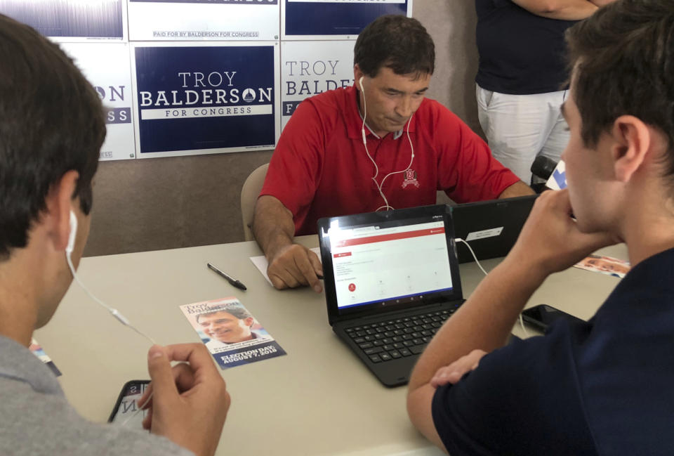 Republican Troy Balderson, a candidate for Ohio's 12th District, joins volunteers at a phone bank in Westerville, Ohio, on Monday, Aug. 6, 2018, a day ahead of a special election for the congressional seat. Balderson, a two-term Republican state senator, is working to retain GOP control of the 12th District. He faces Democrat Danny O'Connor, the Franklin County recorder, whose fundraising outpaced Balderson's during the most recent reporting period by nearly four times. (AP Photo/Julie Carr Smyth)