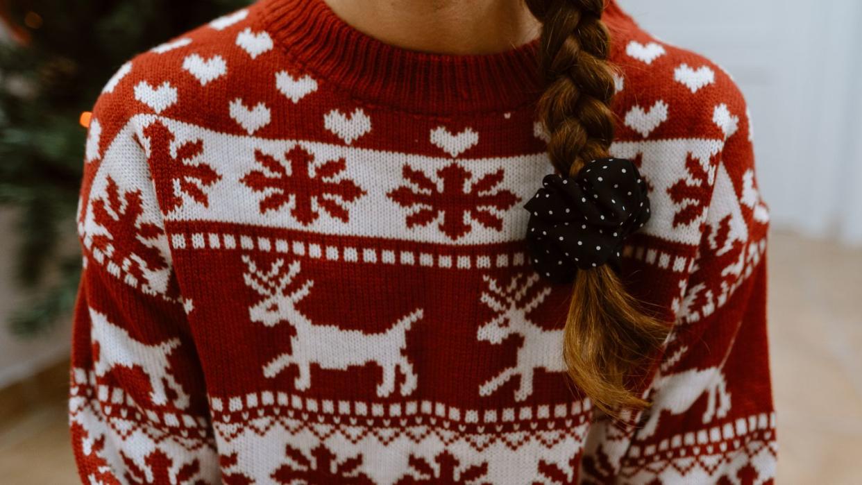woman wearing christmas sweater with long braid